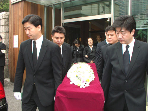 운구 차량으로 옮겨 입관하고 있다. 